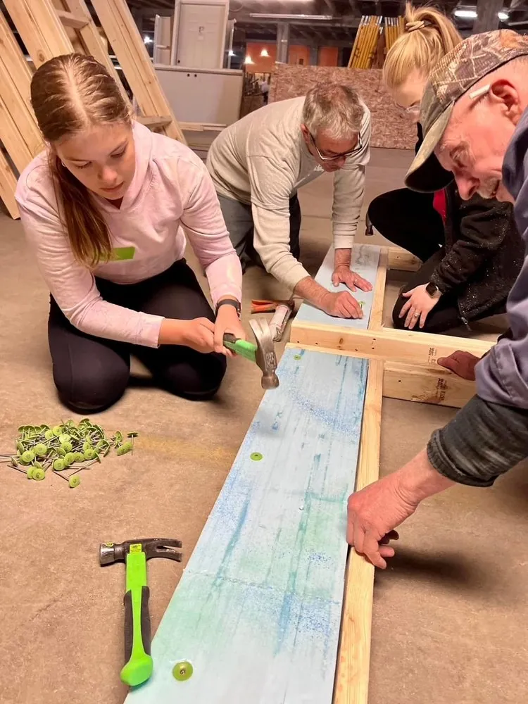 Eliana building a bench for a community project